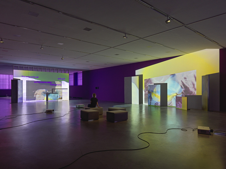 Basel Abbas & Ruanne Abou-Rhame, May amnesia never kiss us on the mouth: Only sounds that tremble through us, 2022, 4-channel video projection (HD, color, sound) on partition wall, metal and concrete panels, photographic gel. Performer: Rima Baransi, Haykal, Julmud, Makimakkuk. Courtesy the artist. Co-commissioned by the Museum of Modern Art, New York, and Dia Art Foundation, New York. Photo: Stefan Altenburger Photography, Zurich