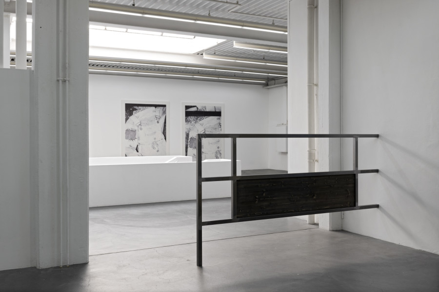 Kelly Tissot, Dubious portrait and improper meeting/Schoolboy II 2022, Dubious portrait and improper meeting/Schoolboy I 2022, Digital UV print on faux leather, each 290 x 210 cm, Coating against nostalgia/Cobalt glints II, 2022, Steel, stained fir wood, 300 x 160 x 5 cm. Ausstellungsansicht Kunsthaus Baselland 2022. Foto: Gina Folly