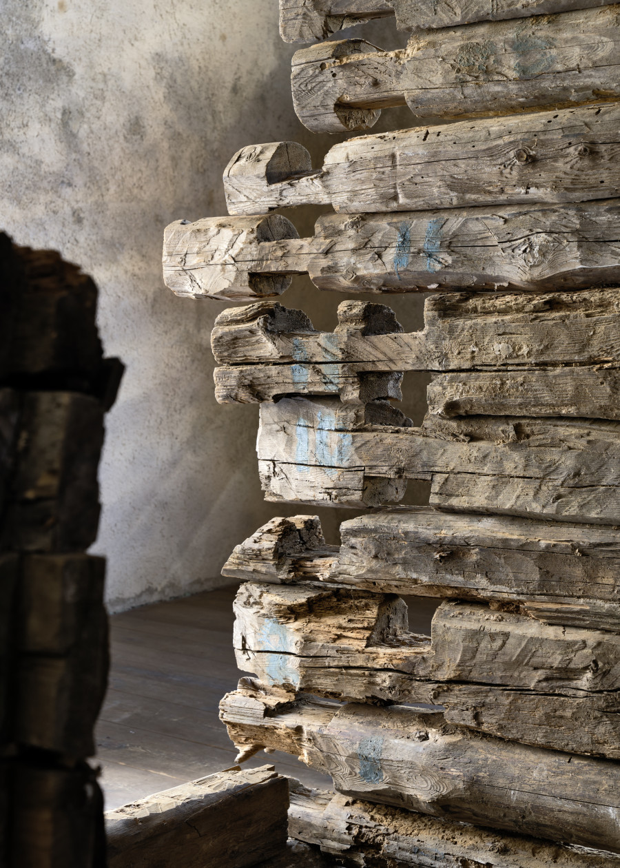 Exhibition view, Augustas Serapinas, Remains of the House from Skirgiškės, 2022, reclaimed wood, 370 x 480 x 500 cm. Photo: Ralph Feiner, Courtesy of the artist and Galerie Tschudi