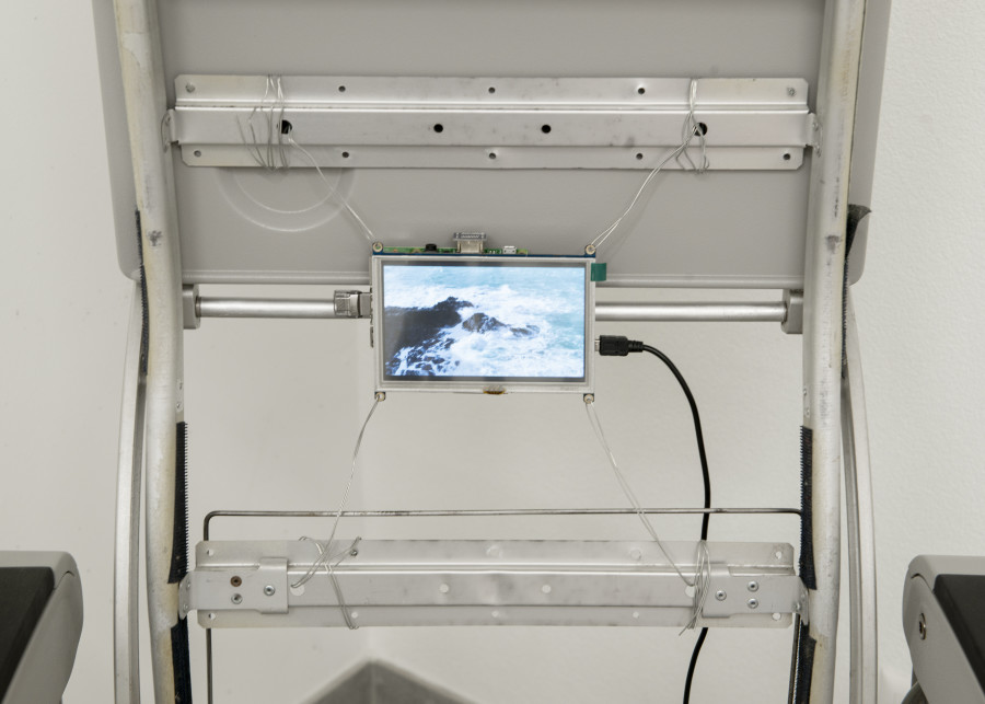 Rafik Greiss, Left to my own devices, 2021, airplane chair with video on LCD screen — Picture © Simon Rimaz