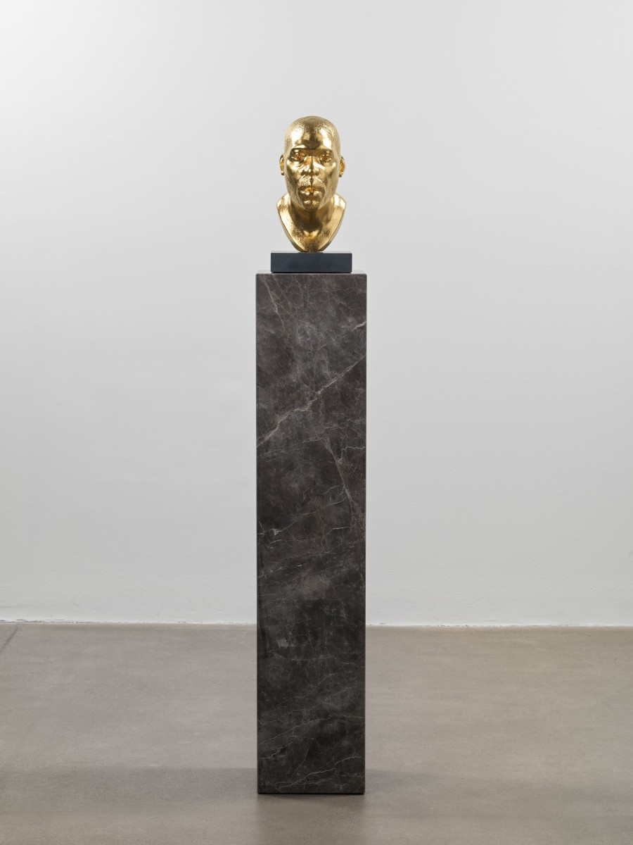 Thomas J Price, Untitled (Icon 3), 2017, 24 ct gold leafed aluminium composite, Italian slate base on quartzite plinth, 144.5 x 23 x 23 cm / 56 7/8 x 9 x 9 in, PRITJ110541. © Thomas J Price. Courtesy the artist and Hauser & Wirth. Photo: Ken Adlard