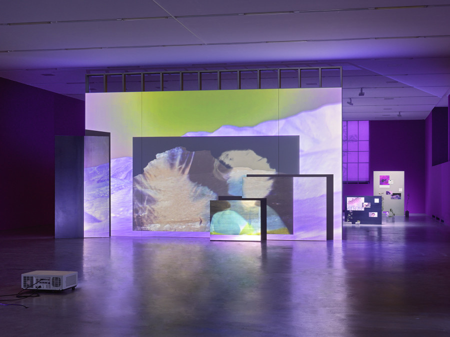 Basel Abbas & Ruanne Abou-Rhame, May amnesia never kiss us on the mouth: Only sounds that tremble through us, 2022, 4-channel video projection (HD, color, sound) on partition wall, metal and concrete panels, photographic gel. Performer: Rima Baransi, Haykal, Julmud, Makimakkuk. Courtesy the artist. Co-commissioned by the Museum of Modern Art, New York, and Dia Art Foundation, New York. Photo: Stefan Altenburger Photography, Zurich